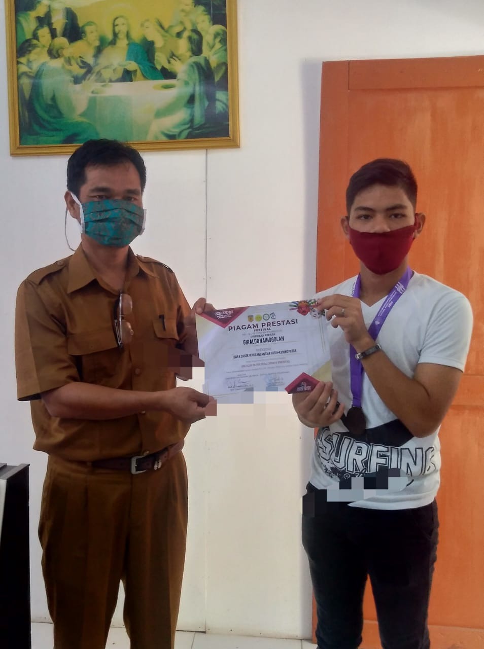 Penasehat Funakoshi Karate-Do Indonesia Kab. Samosir, Bonar Sinaga, S.Ag menyerahkan piagam dan medali pada Giraldo Nainggolan/istimewa